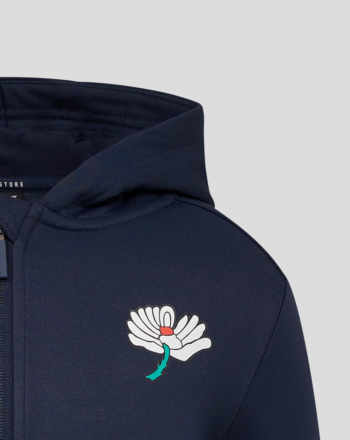 Close up of navy hoodie chest showing the white wing Castore logo with turquoise accent.