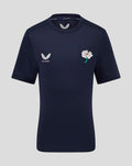 Navy juniors short sleeve training tee featuring left chest wing logo and right chest white floral badge.