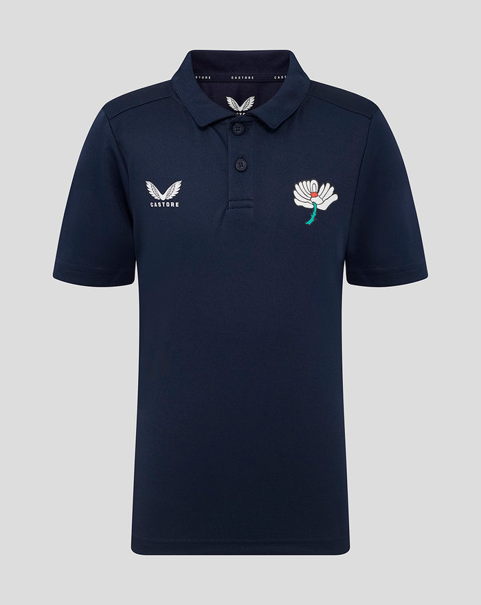 Navy juniors short sleeve polo with Castore wing logo on the left chest and a white flower crest on the right chest.