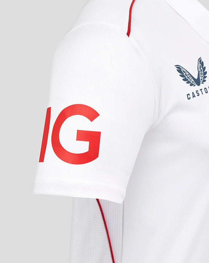 Close up of sleeve showing a bold red graphic on a white ECB replica shirt with Castore branding on the chest