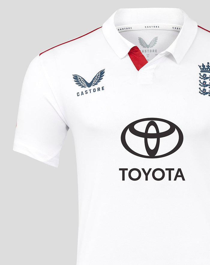 Close up of ECB Test replica shirt showing Castore logo and England badge with red trim at the collar