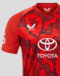 Close up of chest on red England 25/26 T20 shirt featuring large Toyota logo Castore emblem and vivid pattern