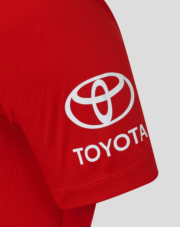 Close up of the right sleeve showing a white Toyota logo on red fabric