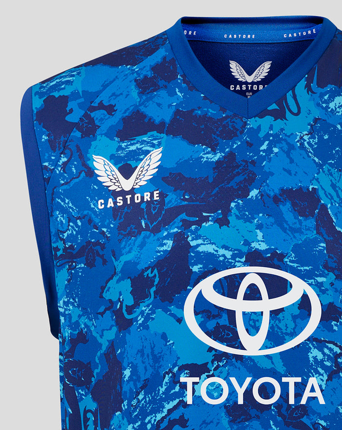 Close-up of the front neckline area showing Castore branding and England crest on the blue camo vest with Toyota logo