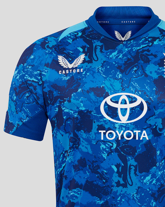 Close-up of the blue camouflage ODI shirt chest area showing the Three Lions crest and Toyota logo