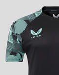 Close-up of shoulder and neckline showing teal patterned sleeve, Castore branding on the collar, and England crest on the chest.
