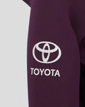 Close up of a purple hoodie sleeve featuring a large white Toyota logo