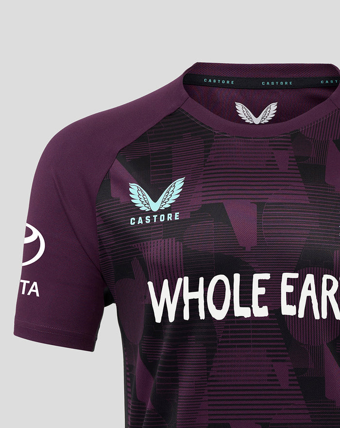 Purple England cricket pro training short sleeve T shirt with Whole Earth logo across the chest and a light blue crest on the left.