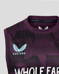 Chest detail of the vest highlighting the light blue England crest and large Whole Earth text on dark purple fabric