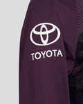 Left sleeve close-up of purple training top with white Toyota emblem.