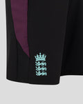 Close-up of black ECB training shorts showing purple side panel and turquoise England crest near the hem.