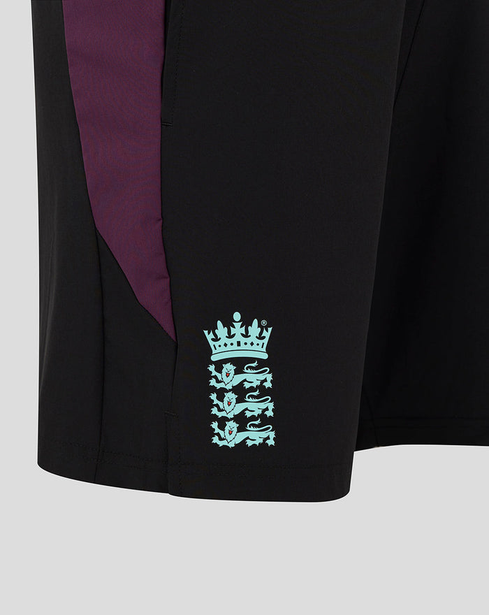 Close-up of black ECB training shorts showing purple side panel and turquoise England crest near the hem.