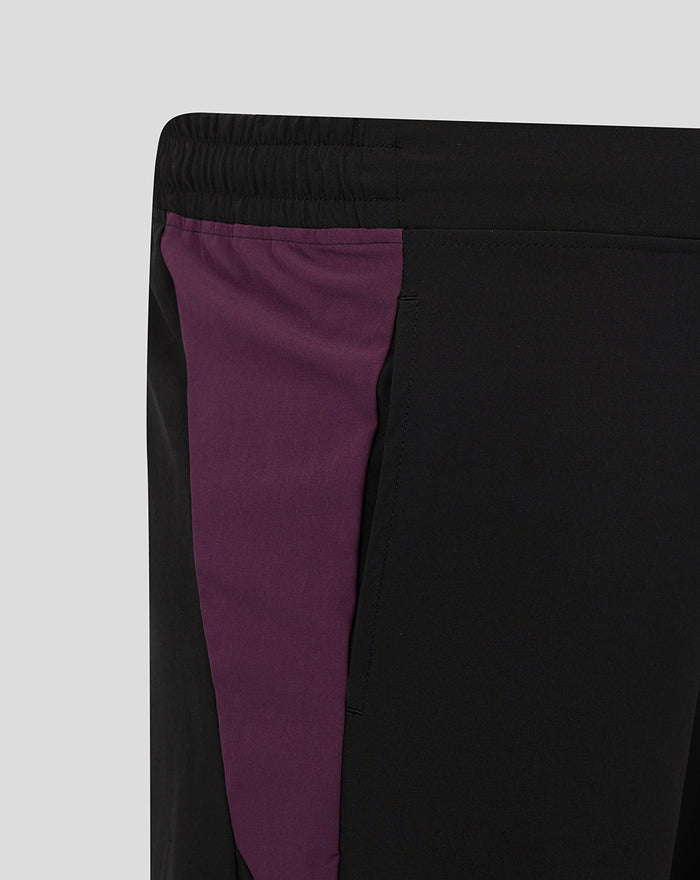 Close-up of ECB training shorts showing black fabric with a purple side panel.