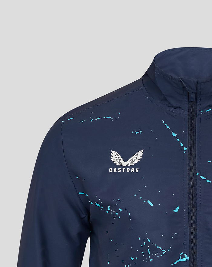 Close-up of chest area on navy Yorkshire Graphic Track Jacket showing Castore logo and turquoise paint splatter near the collar.