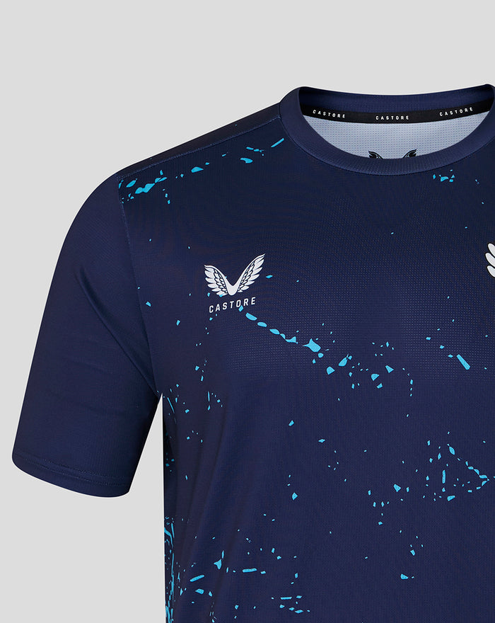 Close up of navy Peacoat T shirt chest featuring White Rose crest and Castore wings with blue splatter.