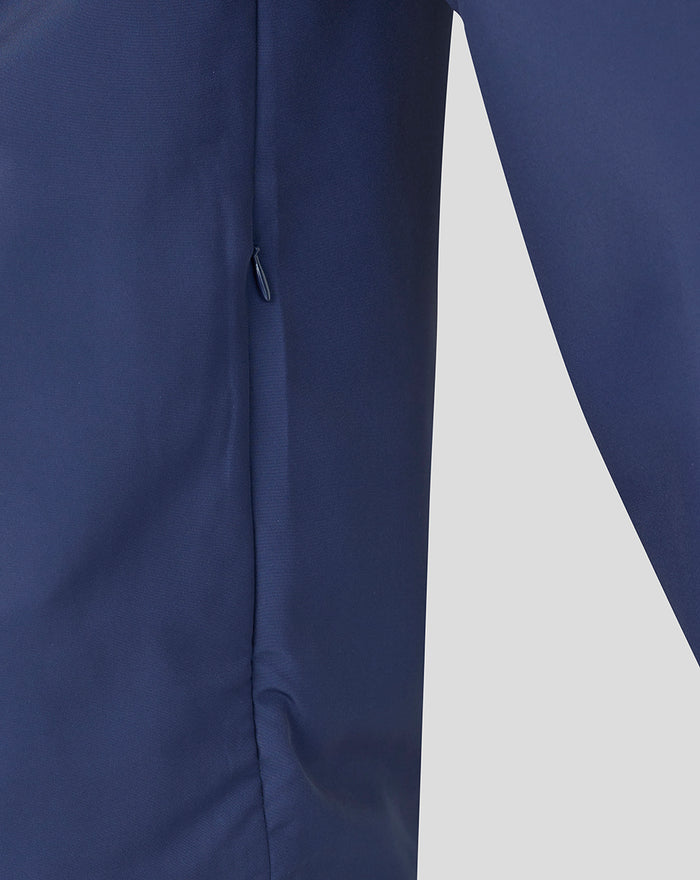 Navy woven pre-match jacket with subtle branding and side zip detail.