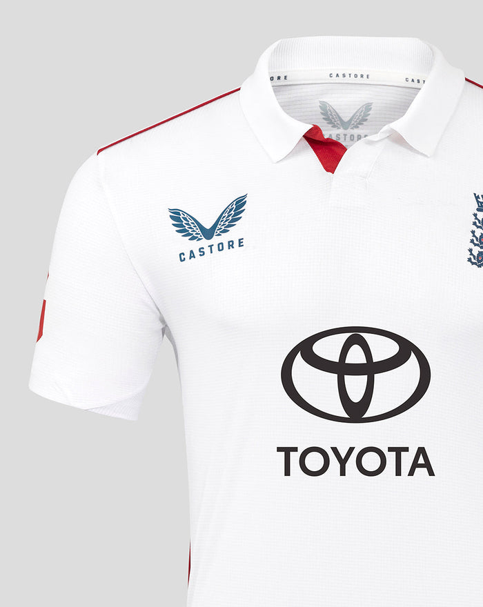 Close up of the white England cricket shirt chest with Castore logo on the left and Toyota emblem center and red shoulder piping.