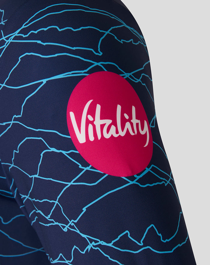 Navy sweatshirt sleeve with pink Vitality patch and bright blue crackle pattern