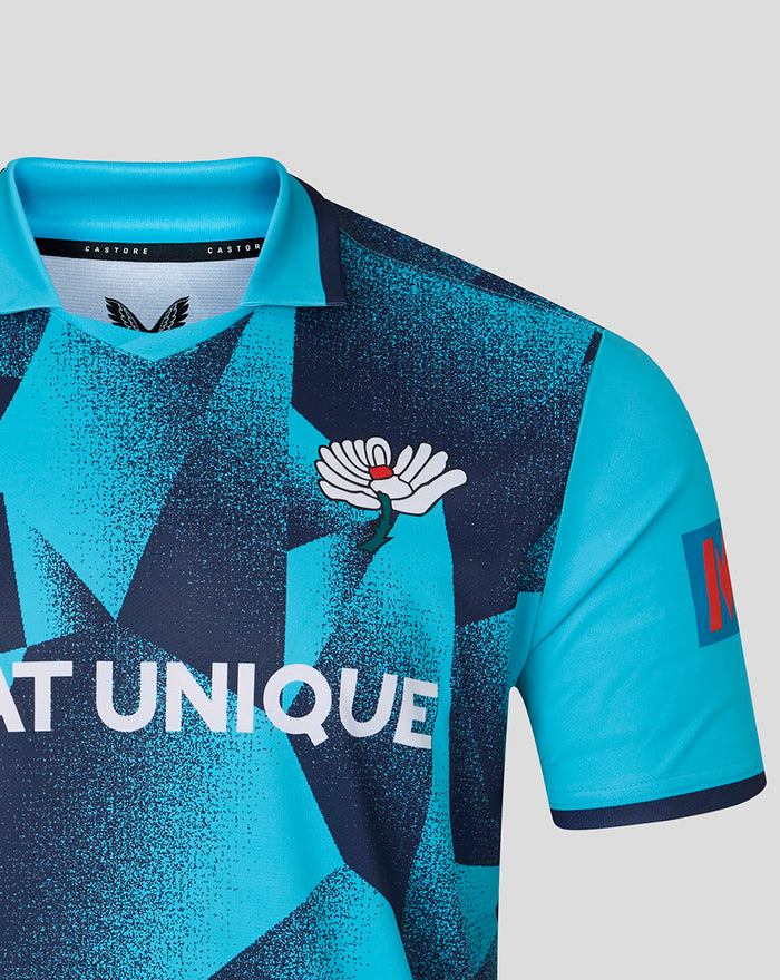 Bright blue geometric One Day cricket jersey featuring a white lotus crest and Seat Unique slogan