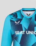 Close up of a blue geometric cricket overshirt with SEAT UNIQUE across the chest