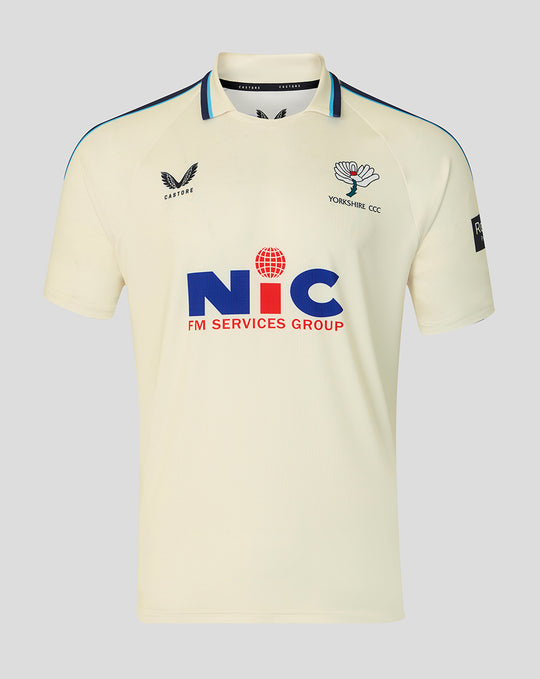 Cream County Championship short sleeve cricket jersey with a classic collar, navy shoulder piping, Yorkshire CCC crest on the left chest and NIC sponsor logo across the front.