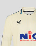 Cream long sleeve cricket jersey front view with Castore logo on chest NIC sponsor and turquoise piping on collar.