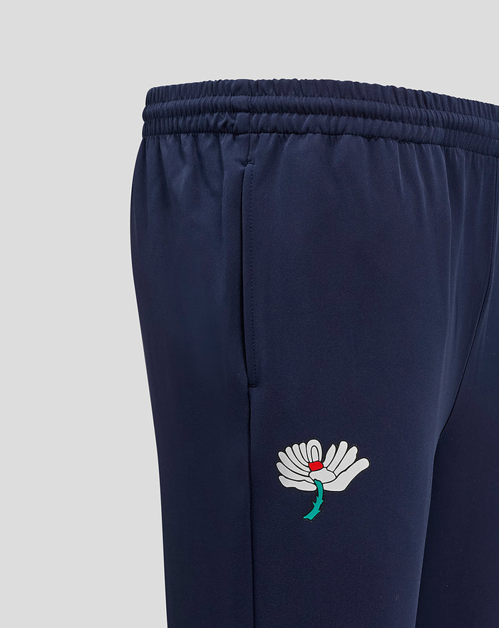 Close-up of navy Yorkshire Track Pant showing side seam and white flower logo on the thigh.