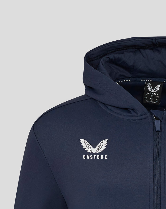 Close-up of navy Yorkshire Zip Through Brushback Hoody with Castore wing logo on chest and hood interior tag