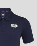 Navy Yorkshire polo with large white floral crest on left chest and teal stem