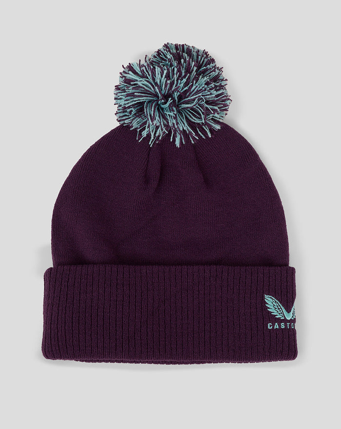 Dark purple ECB training bobble hat with teal faux fur pom and Castore logo on the cuff