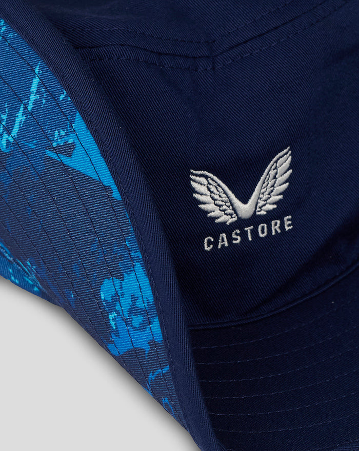 Close up of navy fabric showing Castore wing crest embroidery on the hat